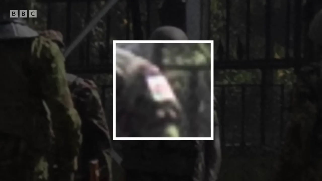 Close-up of the suspect's shoulder badge: a Kenyan flag patch in black, red and green.